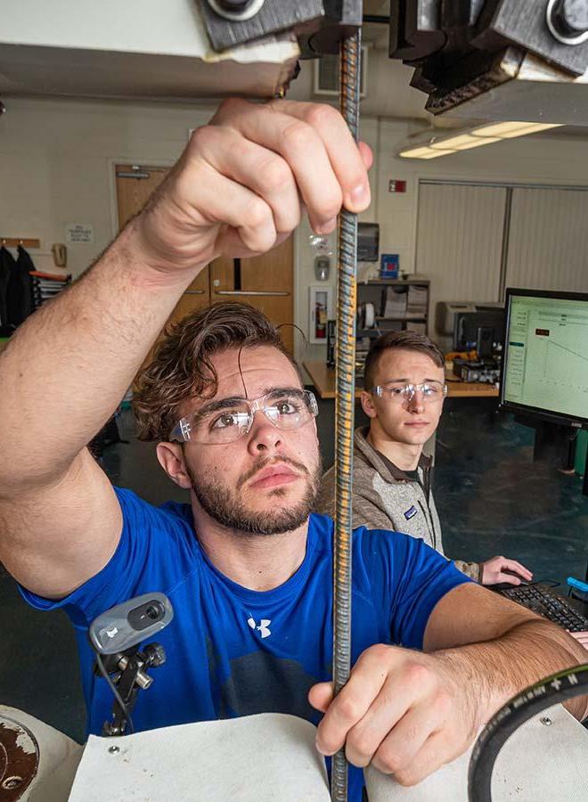 Engineering student cutting rebar